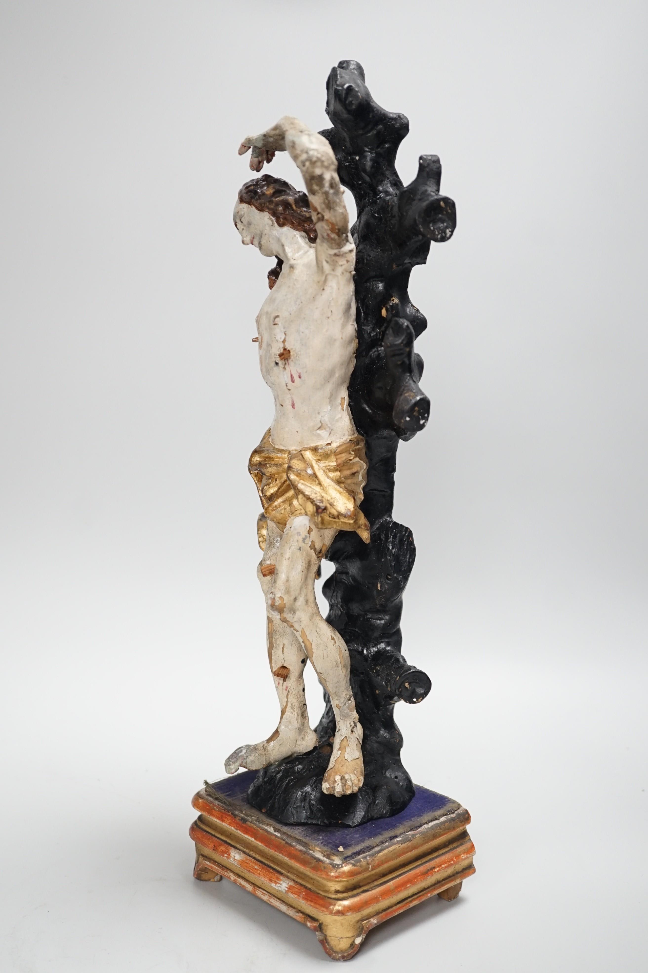 A 19th century Continental carved wooden polychrome figure of St. Sebastian on stand, total height 40cm